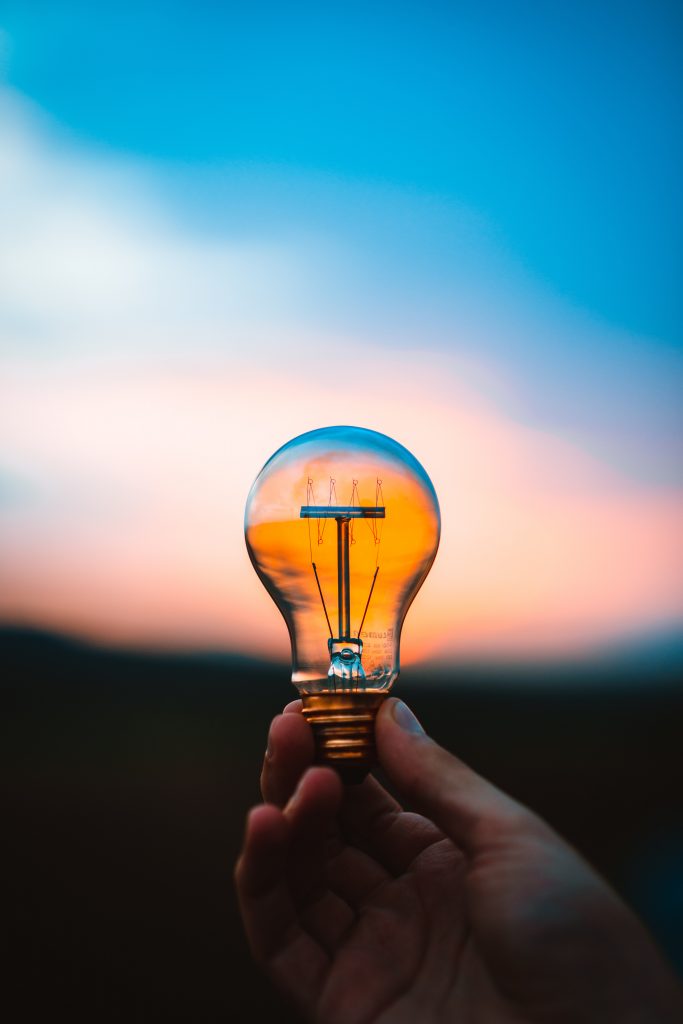 Person holding a light bulb