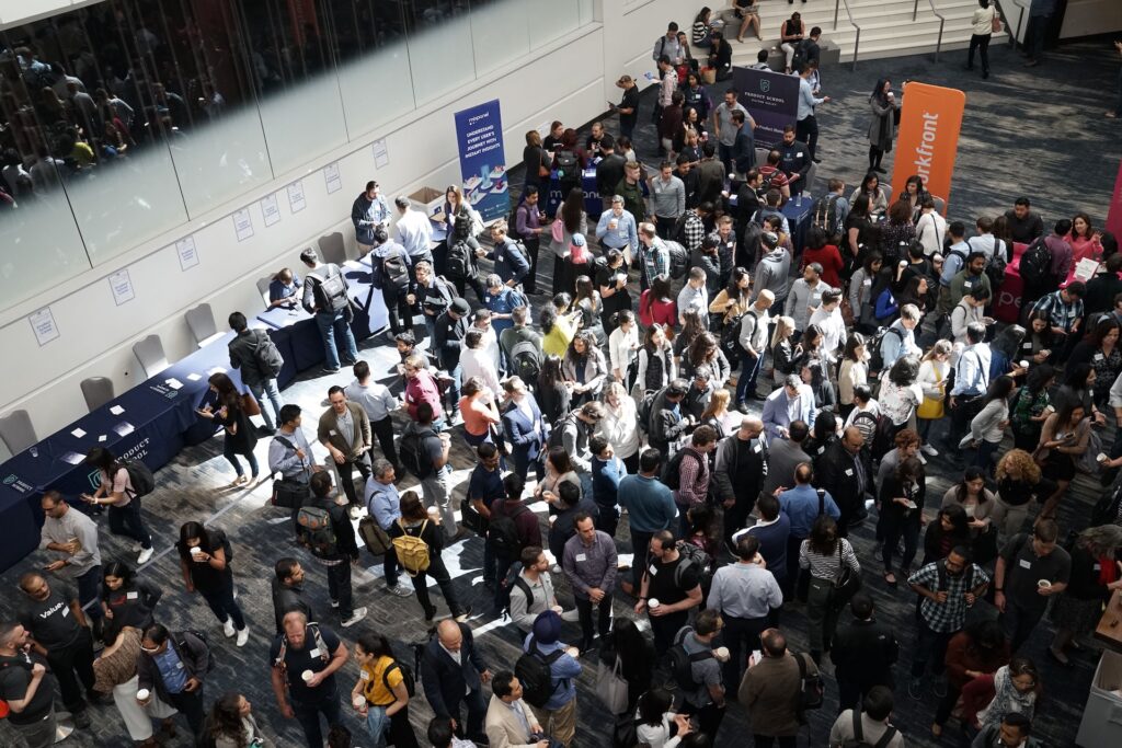 Break through at a conference by standing out from the crowd. Here you see a swarm of people outside of a conference